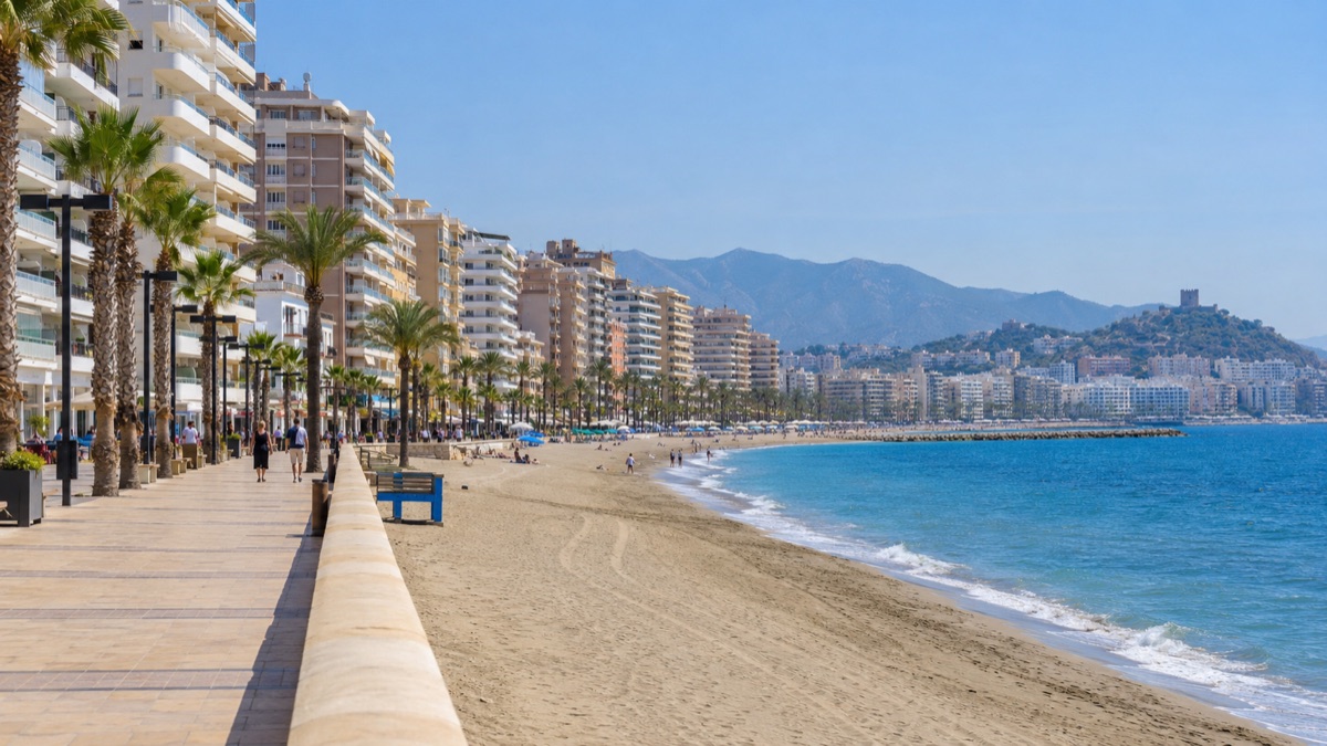 The Fuengirola seafront promenade, apartment blocks and palms along the beach
